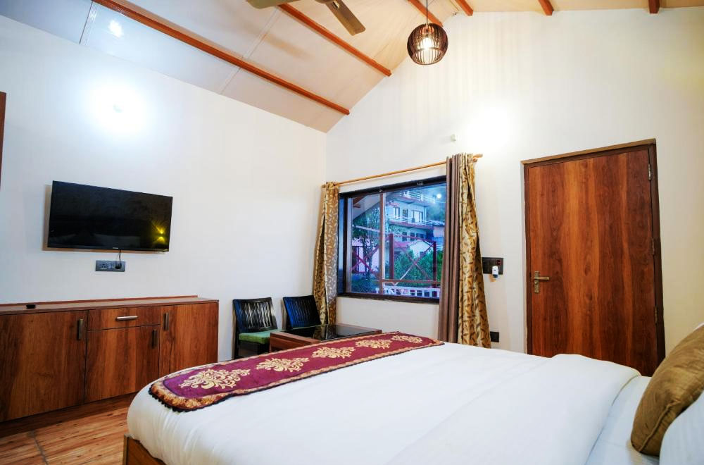 Bedroom with private balcony and lake view at Monal Meadows luxury homestay in Naukuchiatal